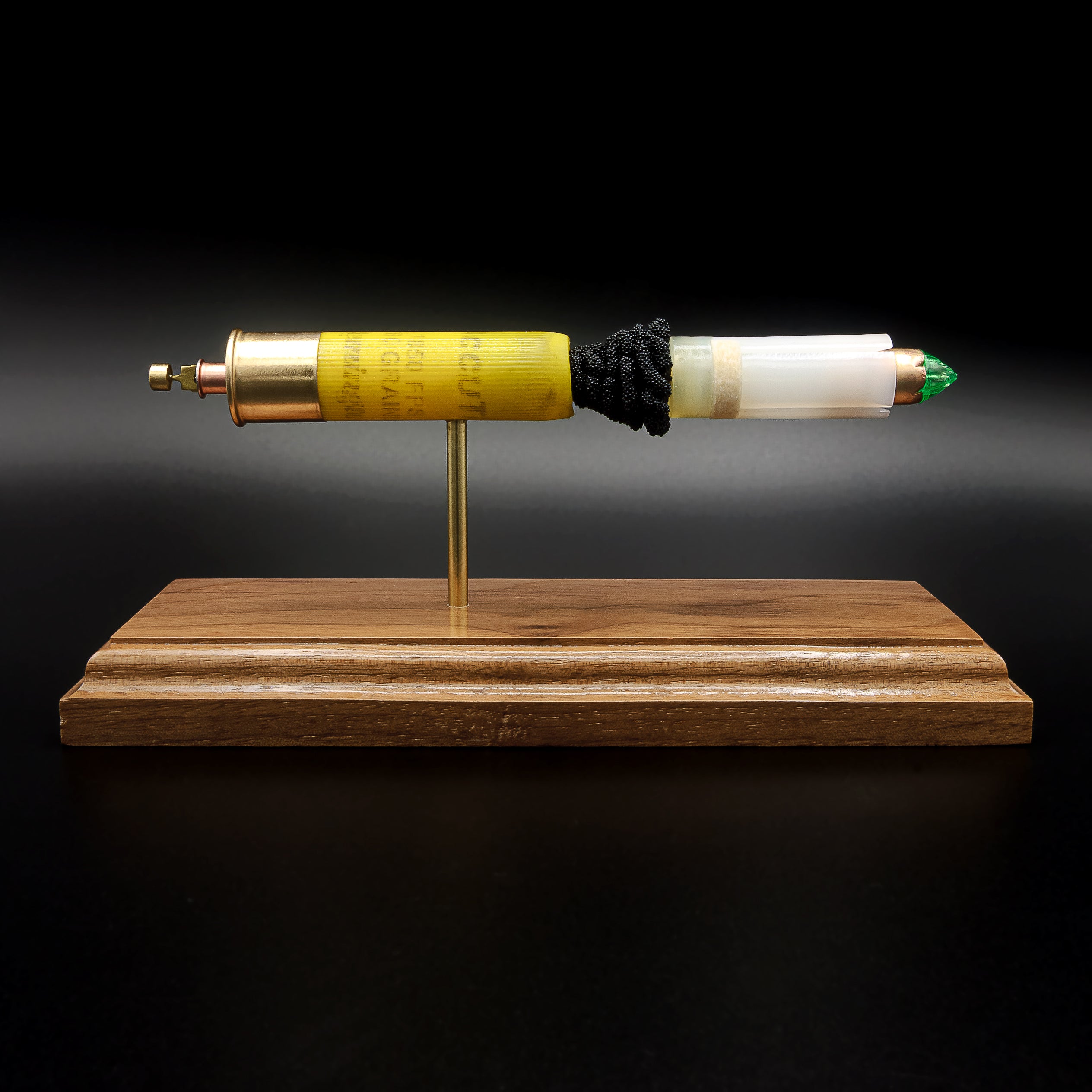 Remington AccuTip 20 gauge slug exploded cartridge display on walnut base showing internal components