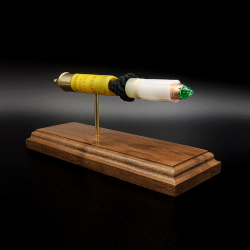 Handcrafted 20 gauge Remington AccuTip slug anatomy display with walnut base and exposed sabot projectile