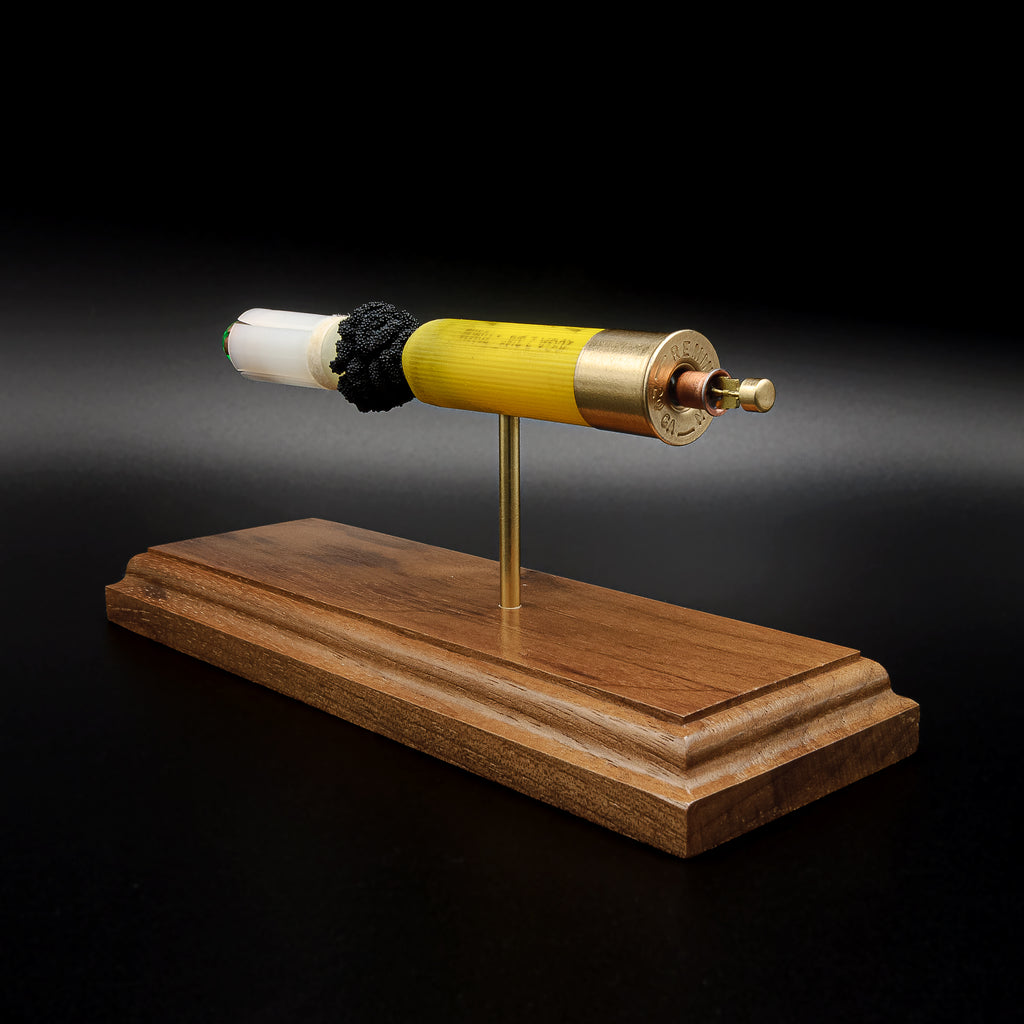 Educational 20 gauge Remington AccuTip slug model with exposed sabot, slug, powder, and primer on walnut base