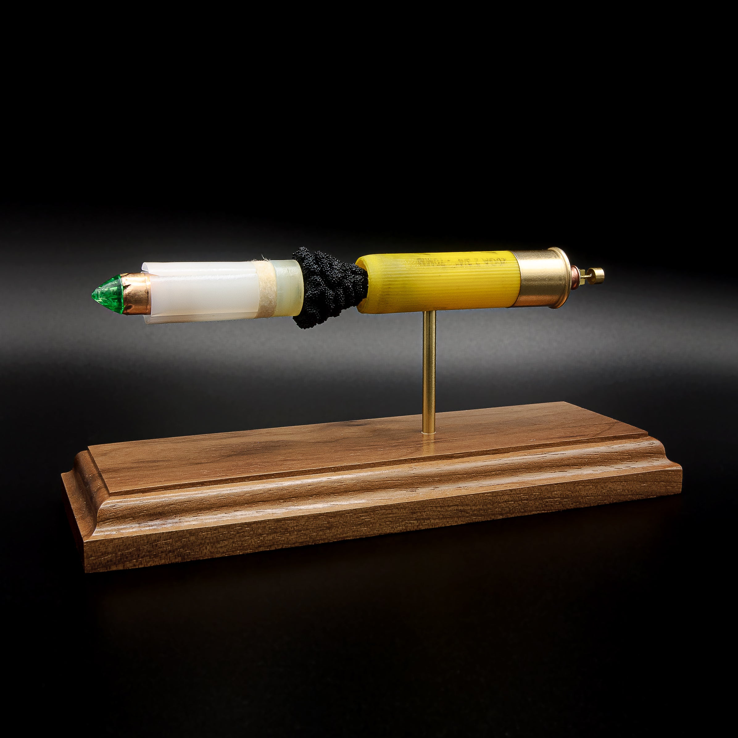 Detailed Remington AccuTip 20 gauge slug exploded ammunition display mounted on a handcrafted walnut wood base