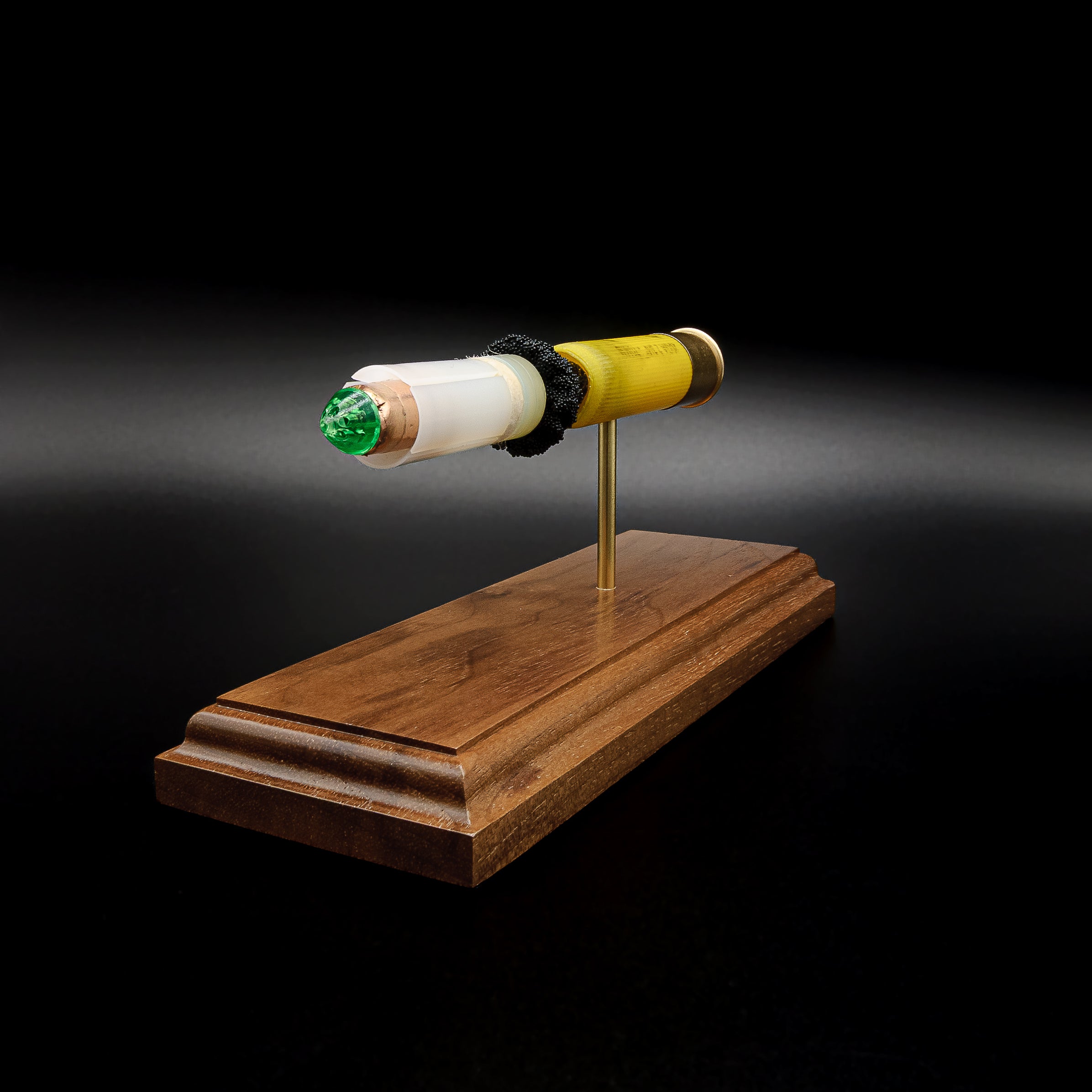 Premium walnut display featuring a 20 gauge Remington AccuTip slug anatomy model with realistic internal construction
