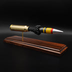 Angled front view of a 20mm Vulcan SAPHEI round on a Bolivian rosewood base, showing the painted projectile tip and exposed internal section