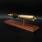 Back-side perspective of a 20mm Vulcan round with separated components, highlighting the brass casing and internal structure on a wood base