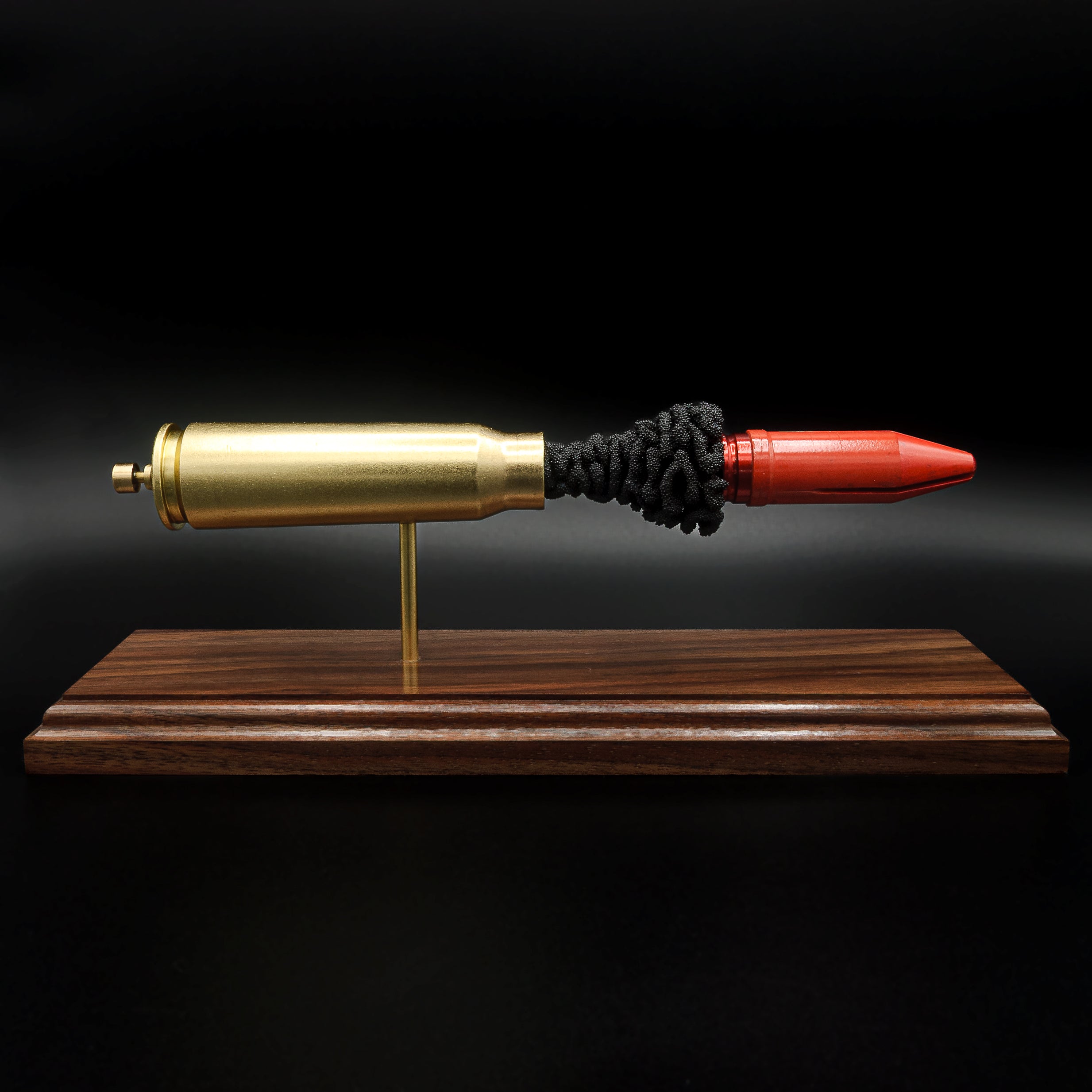 20mm Vulcan MK244 APDS exploded ammunition display mounted on a handcrafted walnut wood base