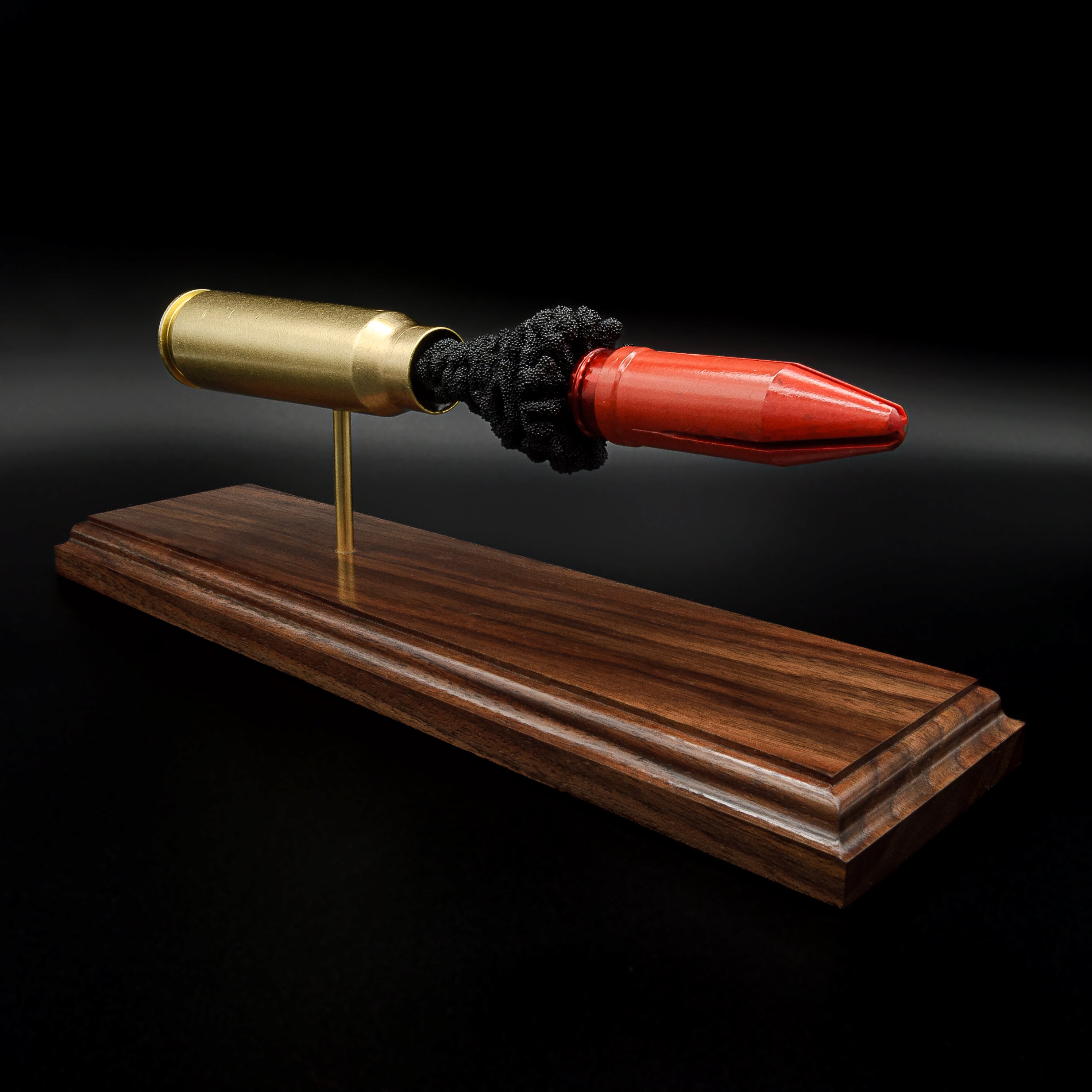 Inert 20mm Vulcan MK244 APDS educational display showcasing internal cartridge components on a walnut base
