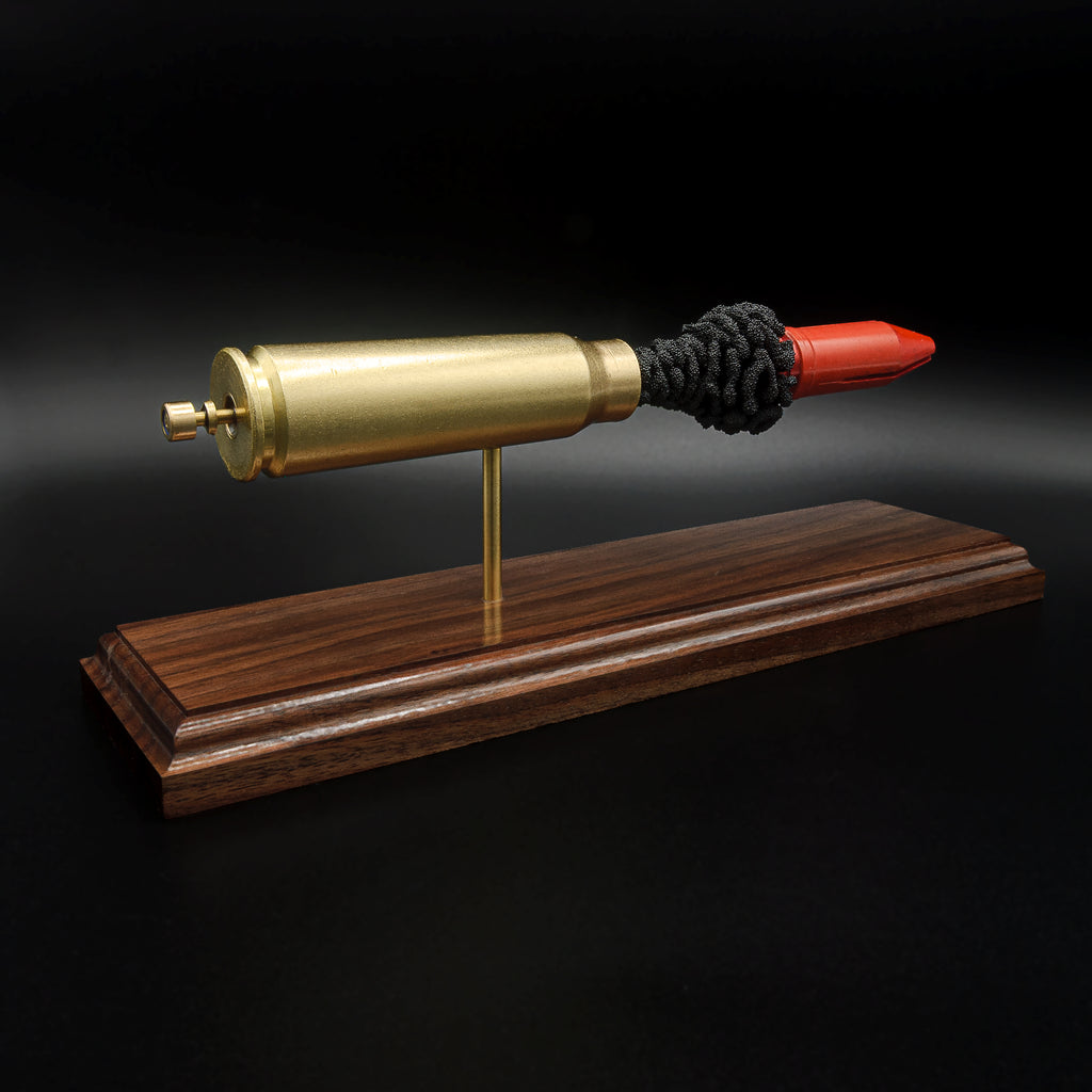 Detailed 20mm Vulcan MK244 APDS exploded round display featuring the red sabot projectile on a premium walnut wood base