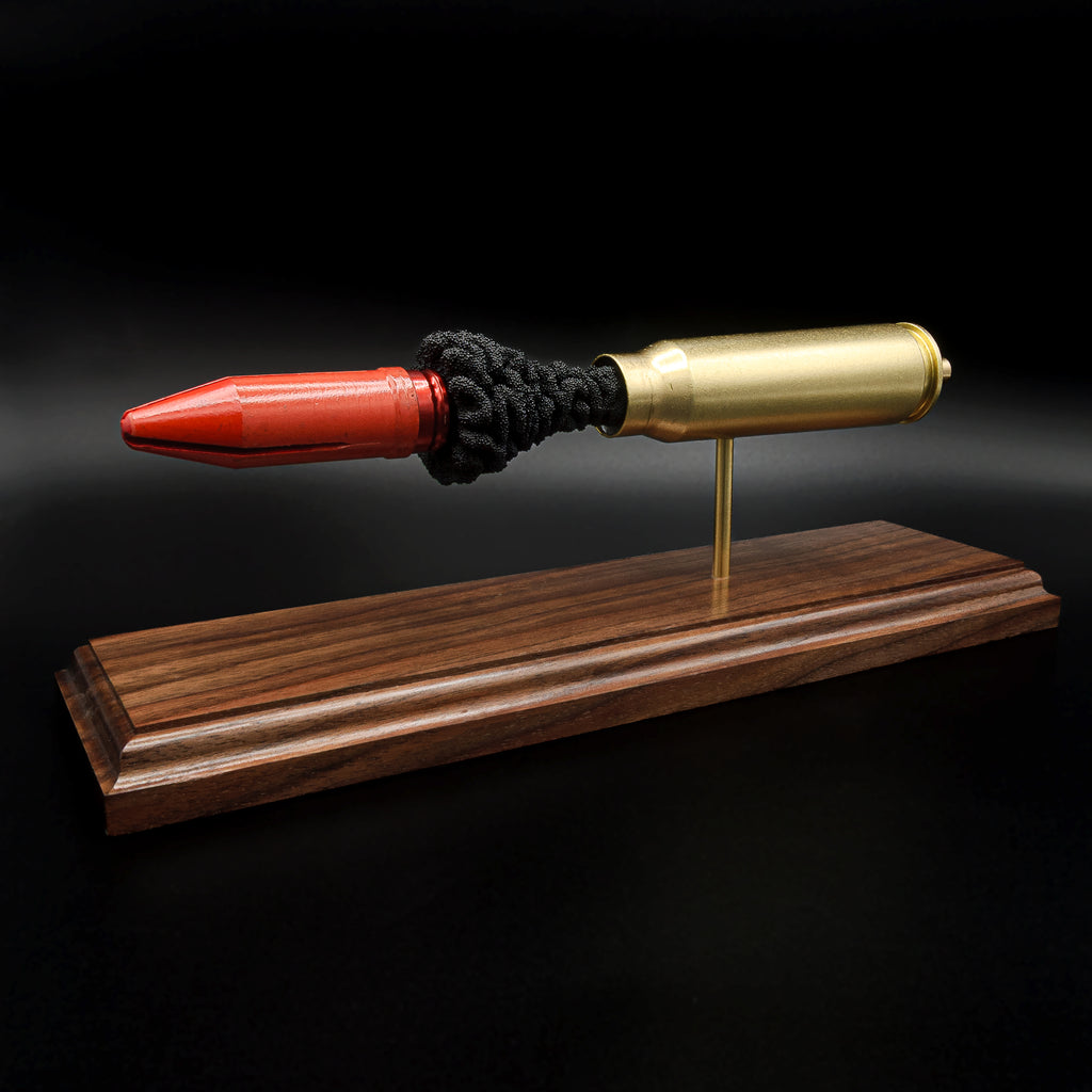Collectible 20mm Vulcan MK244 APDS ammunition anatomy display highlighting the internal construction on walnut wood