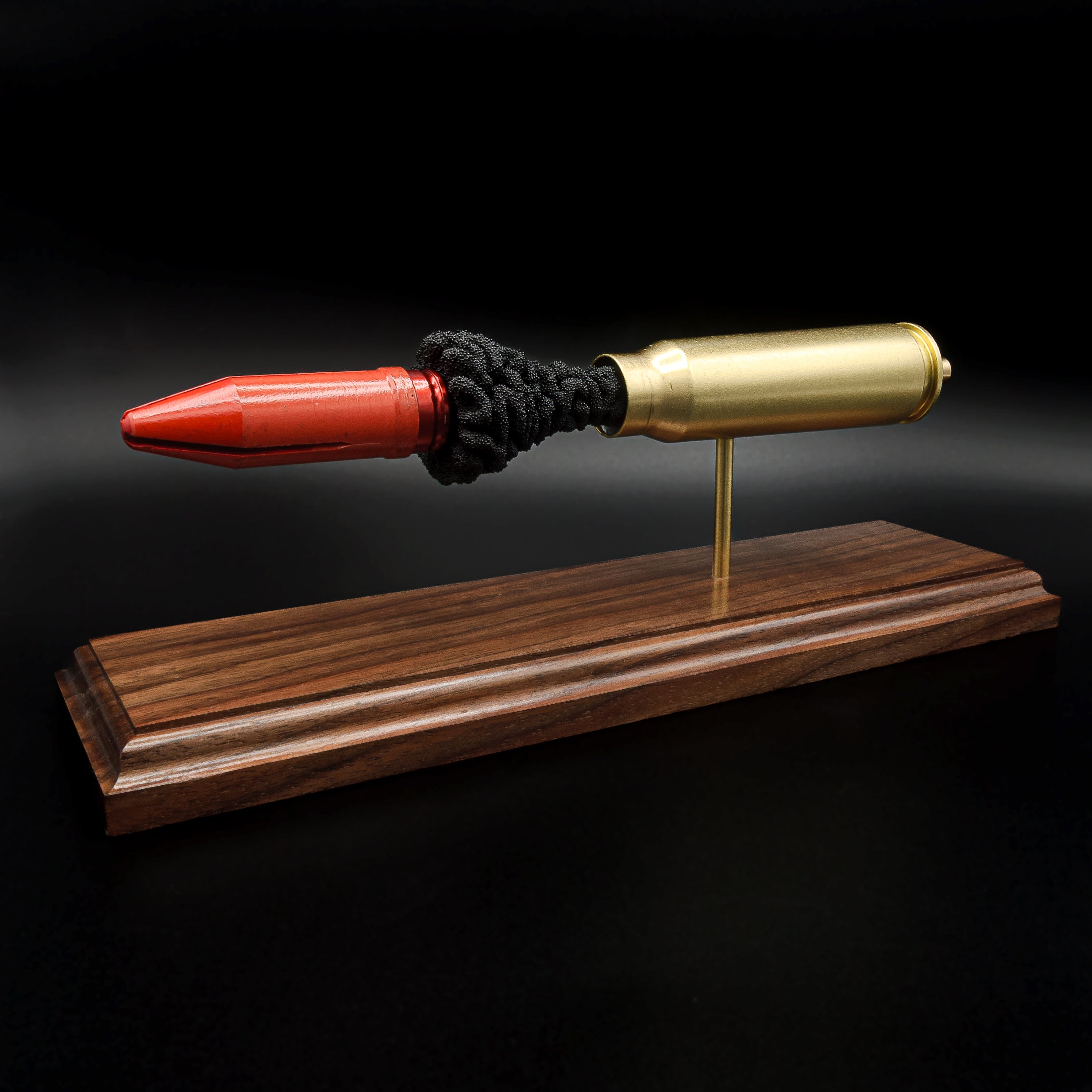 Collectible 20mm Vulcan MK244 APDS ammunition anatomy display highlighting the internal construction on walnut wood