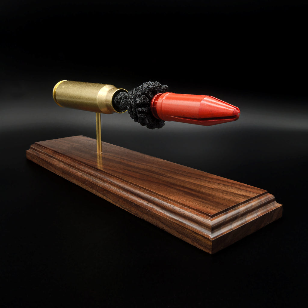 20mm Vulcan MK244 APDS inert display showing the sabot projectile and cartridge anatomy mounted on a handcrafted walnut base