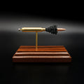 Side profile of a handcrafted .223 Remington FMJ anatomy cartridge display showcasing the exposed internal components including the bullet, brass case, simulated powder, primer assembly, and Bolivian rosewood base.