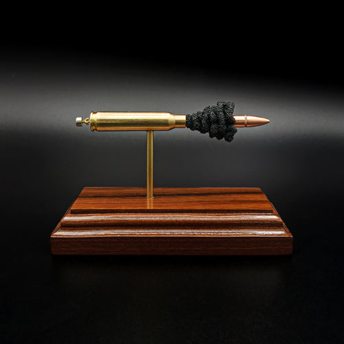 Side profile of a handcrafted .223 Remington FMJ anatomy cartridge display showcasing the exposed internal components including the bullet, brass case, simulated powder, primer assembly, and Bolivian rosewood base.
