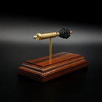 Angled view of an inert .223 Remington FMJ cutaway cartridge display highlighting the brass case, separated projectile, simulated powder, expanded primer components, and premium Bolivian rosewood display base.
