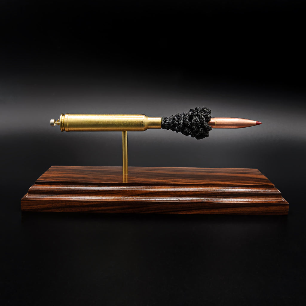 Front view of a .300 Weatherby Magnum Hornady Precision Hunter 200gr ELD-X cartridge anatomy display showing the primer cup, anvil, cartridge case, simulated powder, and projectile on a Bolivian rosewood base.