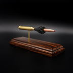 Side view of a .300 Weatherby Magnum Hornady Precision Hunter 200gr ELD-X cartridge anatomy display with the primer cup, anvil, cartridge case, simulated powder, and projectile visible on a Bolivian rosewood base.
