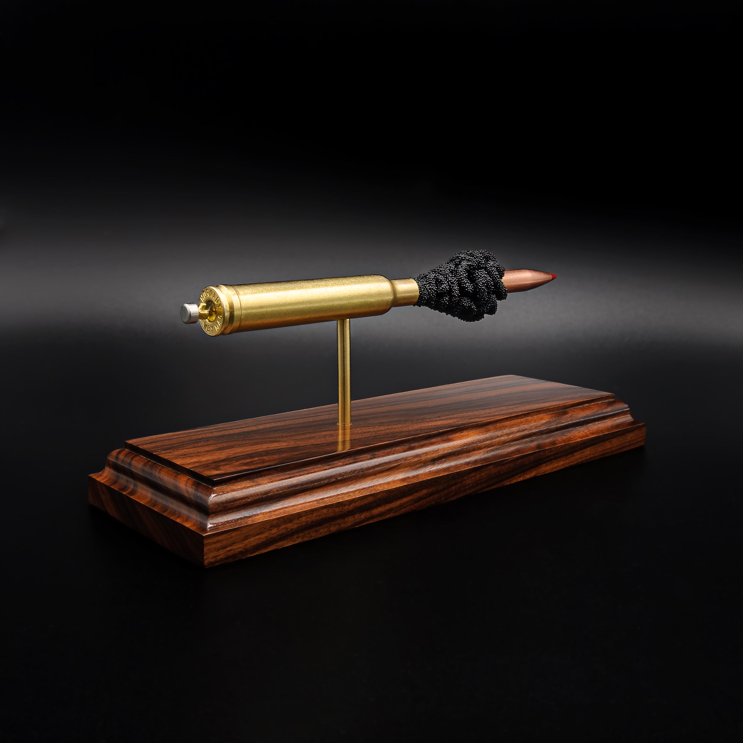 Rear view of a .300 Weatherby Magnum Hornady Precision Hunter 200gr ELD-X cartridge anatomy display showing the cartridge case head, primer cup, anvil, simulated powder, and projectile on a Bolivian rosewood base.