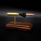 Angled view of a .300 WSM cartridge anatomy display highlighting the projectile, simulated powder, cartridge case, primer cup, and anvil on a Bolivian rosewood base.