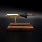 Front view of a .300 WSM cartridge anatomy display showing the primer cup, anvil, cartridge case, simulated powder, and projectile on a Bolivian rosewood base.