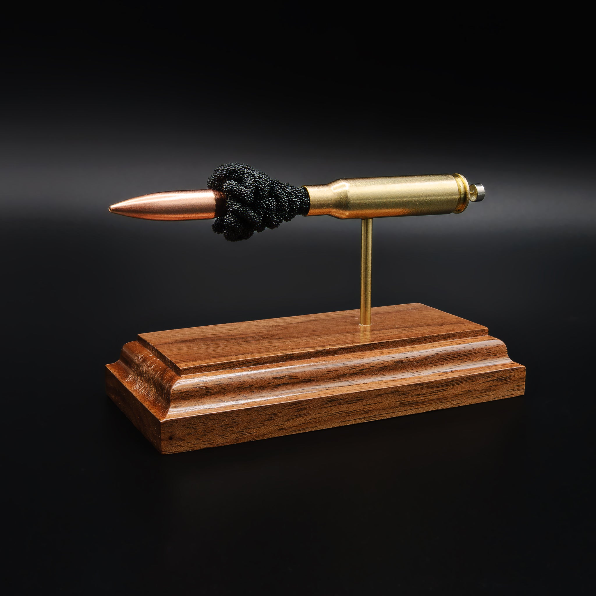 Angled view of 308 Winchester 168gr Sierra MatchKing cartridge display on walnut base