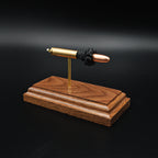 Angled view of 30 Carbine full metal jacket cartridge display on walnut base