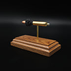 Back angled view of 30 Carbine FMJ cartridge anatomy model on walnut base