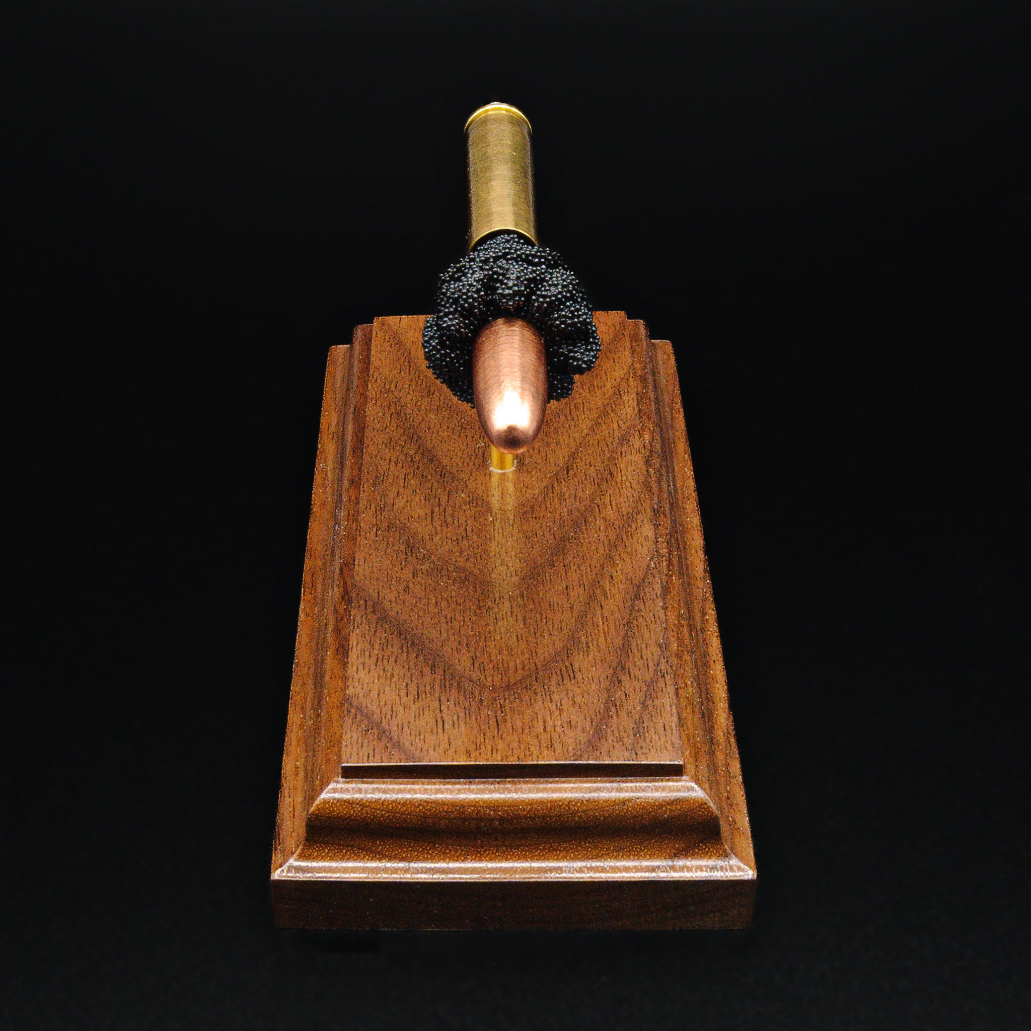 Top-down view of 30 Carbine exploded cartridge showing full component alignment