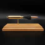 Side profile of .338 Lapua Magnum cartridge anatomy model featuring Barnes TTSX bullet on cherry wood base