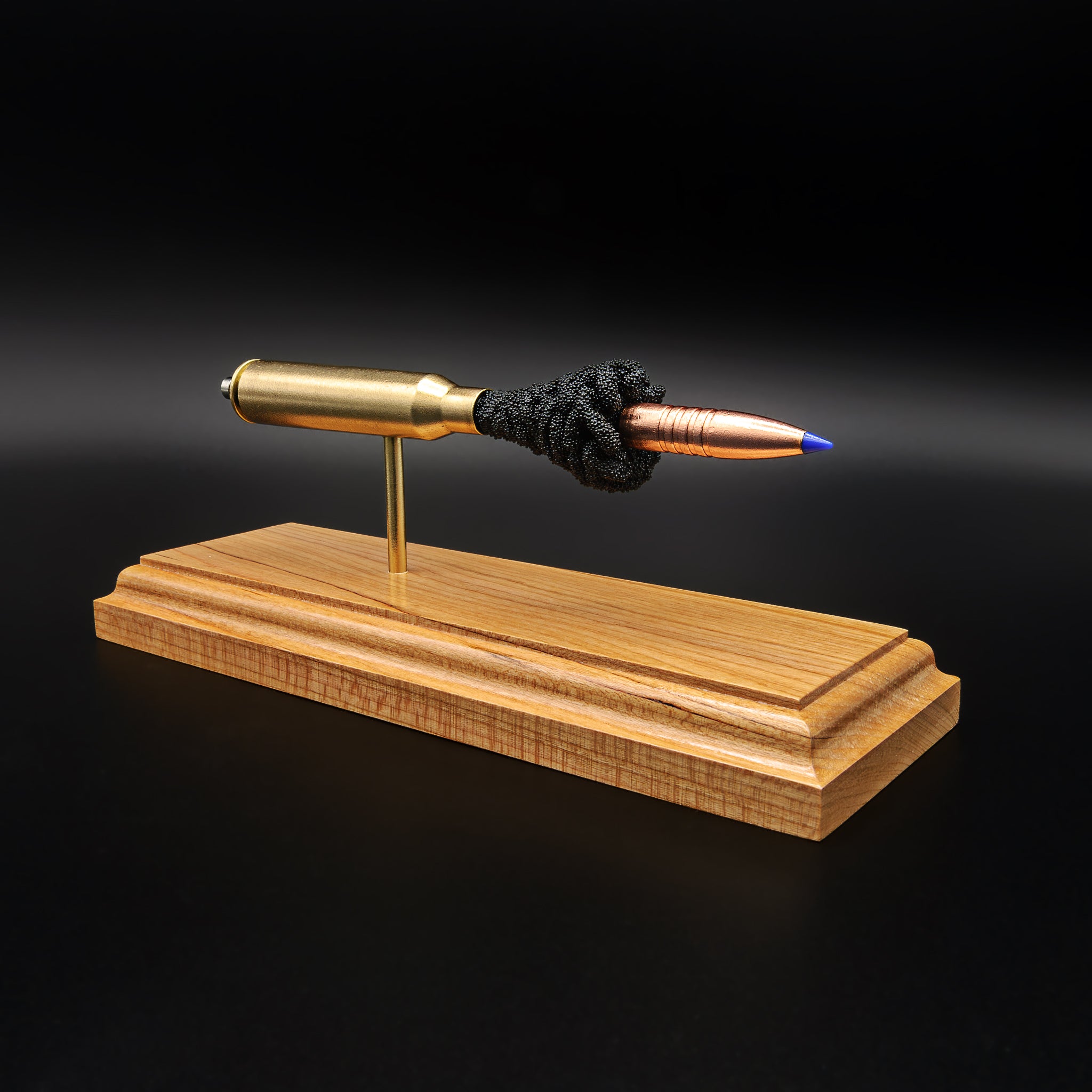 .338 Lapua Magnum Barnes TTSX exploded cartridge anatomy model displayed on a cherry wood base