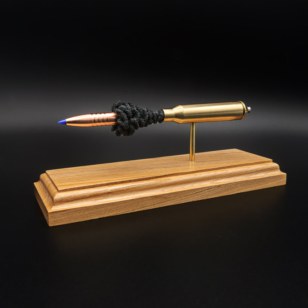 Opposite side view of .338 Lapua Magnum cartridge anatomy model with aligned components on cherry base