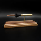 Opposite side profile of an inert .338 Winchester Magnum exploded cartridge display featuring a Sierra MatchKing HPBT 300gr bullet, exposed simulated powder, and handcrafted walnut base.