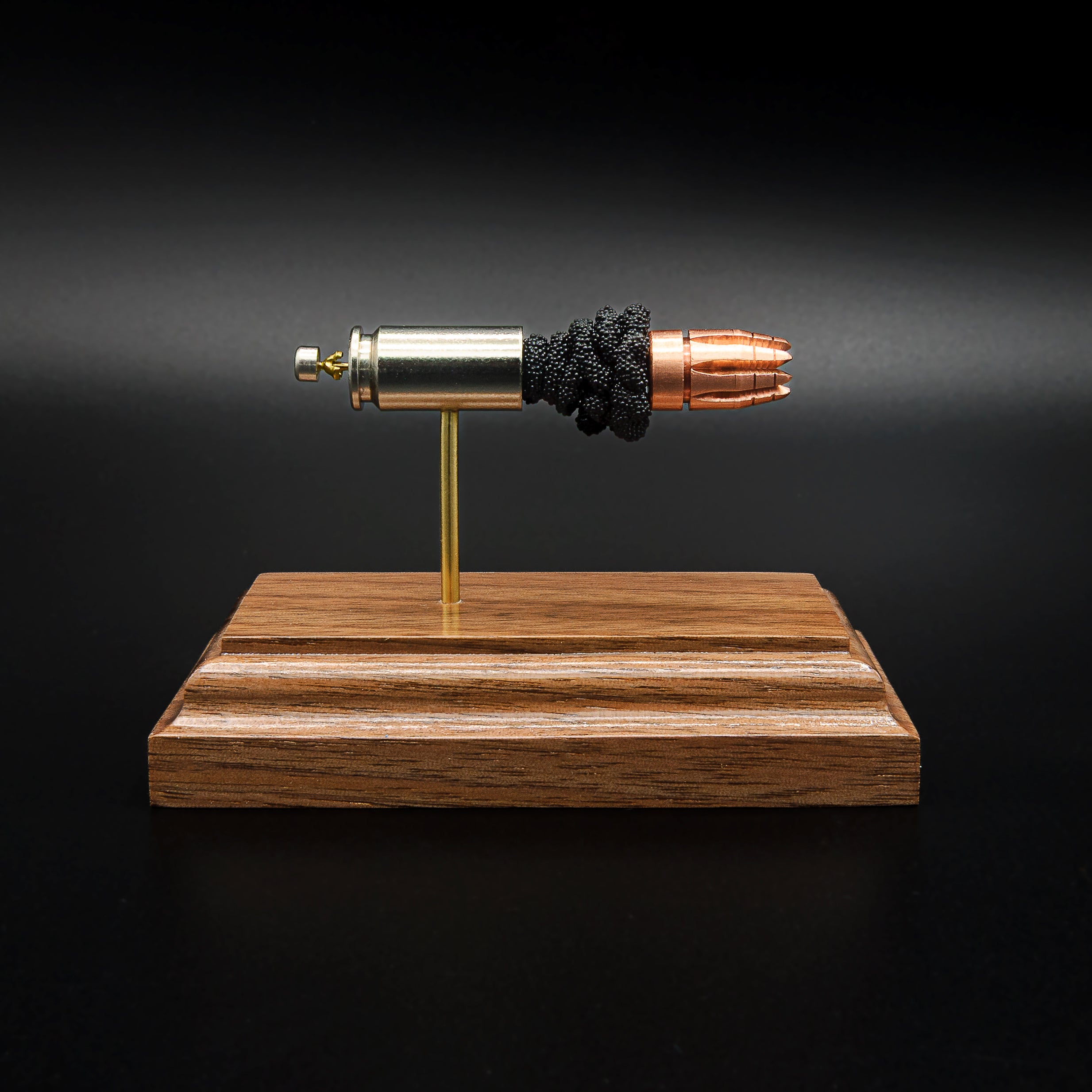 G2 Research RIP 40 S&W cartridge model with separated components on walnut base