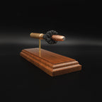 Side view of a .416 Rigby Hornady DGX cartridge anatomy display with the primer cup, anvil, cartridge case, simulated powder, and projectile visible on a walnut wood base.