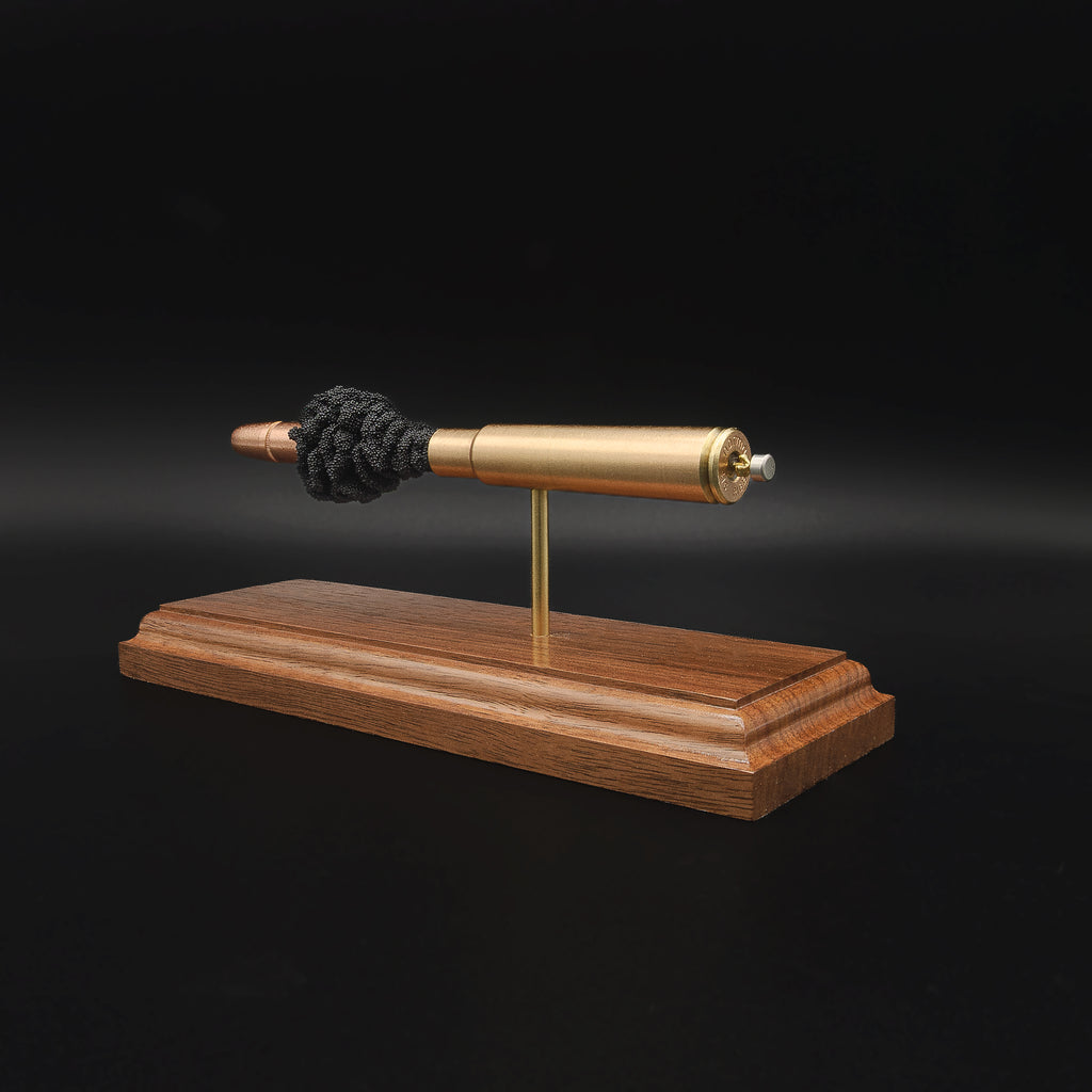 Opposite side view of a .416 Rigby Hornady DGX cartridge anatomy display showing the primer cup, anvil, cartridge case, simulated powder, and projectile on a walnut wood base.