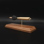 Opposite side view of a .416 Rigby Hornady DGX cartridge anatomy display showing the primer cup, anvil, cartridge case, simulated powder, and projectile on a walnut wood base.