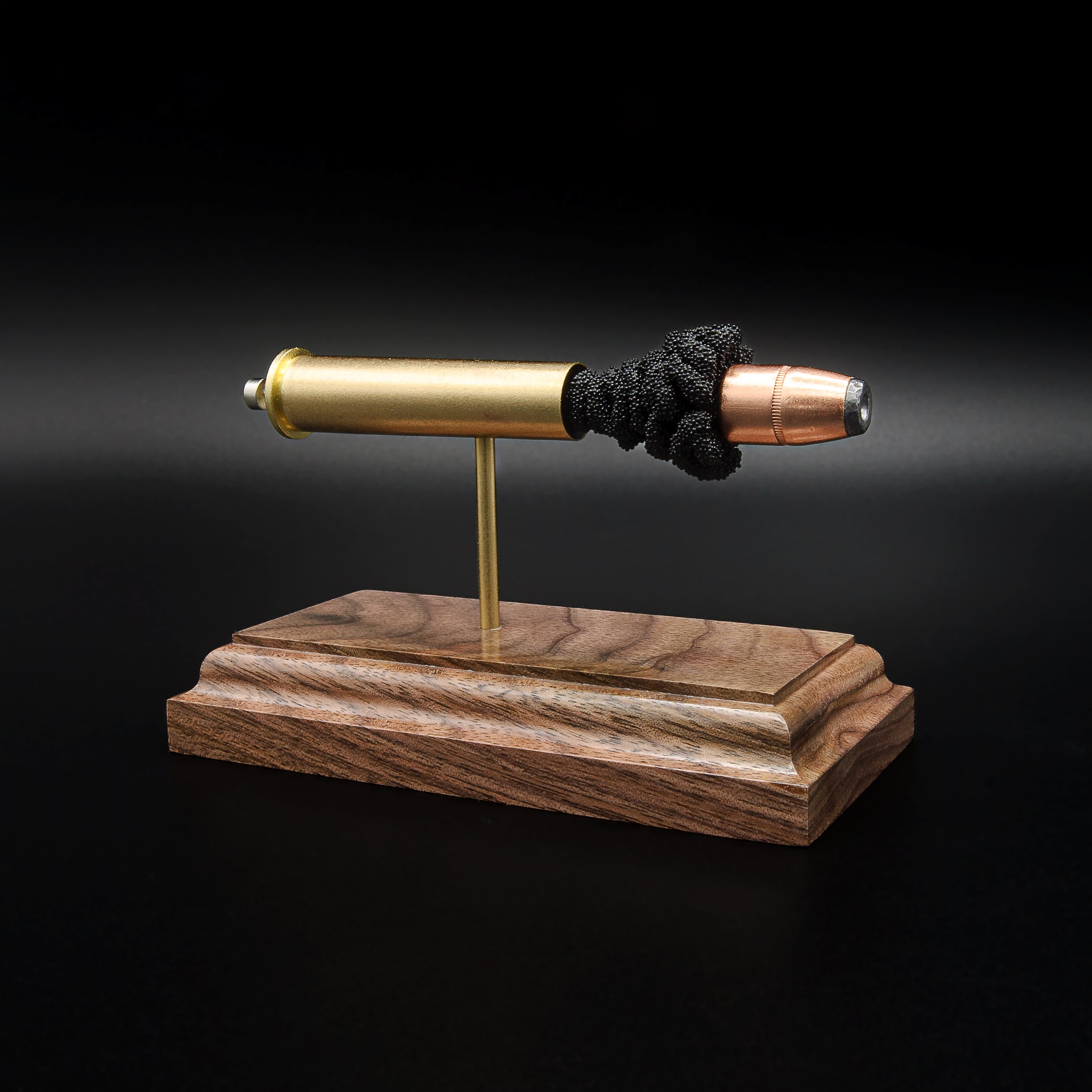 Front three-quarter view of a .45-70 Government anatomy cartridge display highlighting the Hornady 300gr InterLock hollow point bullet and walnut display base.