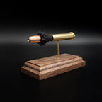 Left-rear perspective of a handcrafted .45-70 Government cartridge display featuring a brass case, Hornady InterLock HP bullet, and solid walnut base.