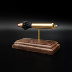 Rear three-quarter view of a .45-70 Government exploded cartridge display emphasizing the cartridge base, primer assembly, and walnut presentation stand.