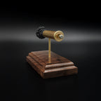 Close rear perspective of a .45-70 Government anatomy display highlighting the brass case head, primer details, and handcrafted walnut base.