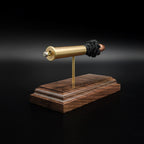 Angled rear view of an inert .45-70 Government exploded cartridge with a Hornady 300gr InterLock hollow point bullet, simulated powder, and walnut display base.