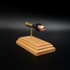 Front-left three-quarter view of a handcrafted .454 Casull exploded cartridge display featuring a Hornady XTP JHP 300gr bullet with simulated powder on a cherry wood base.