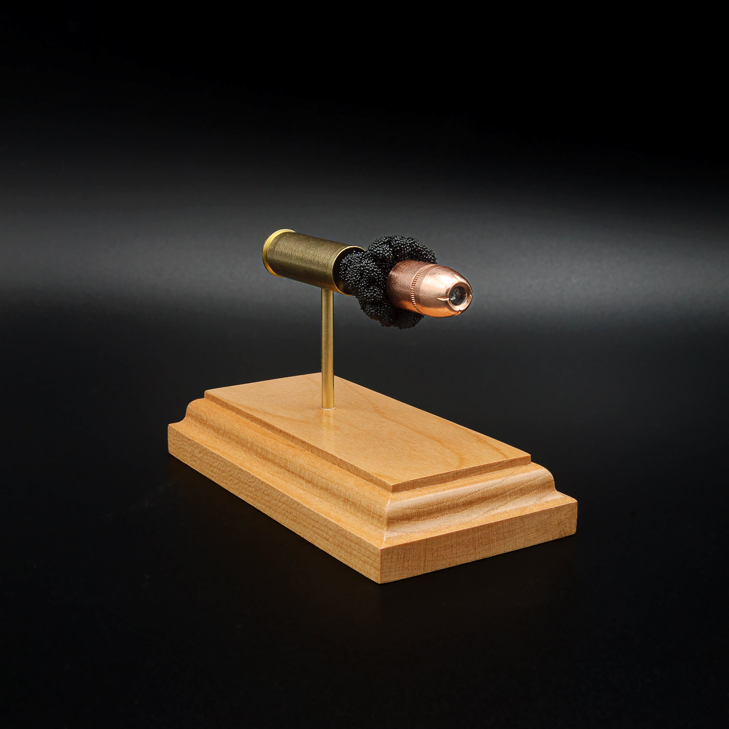 Front-left three-quarter view of a handcrafted .454 Casull exploded cartridge display featuring a Hornady XTP JHP 300gr bullet with simulated powder on a cherry wood base.