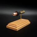 Front-right angle of an inert .454 Casull anatomy cartridge display showcasing the Hornady XTP JHP 300gr hollow point bullet, exposed simulated powder, and handcrafted cherry wood base.