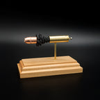 Side profile of a .454 Casull exploded ammunition display with a Hornady XTP JHP 300gr bullet, brass case, exposed simulated powder, and cherry wood presentation base.