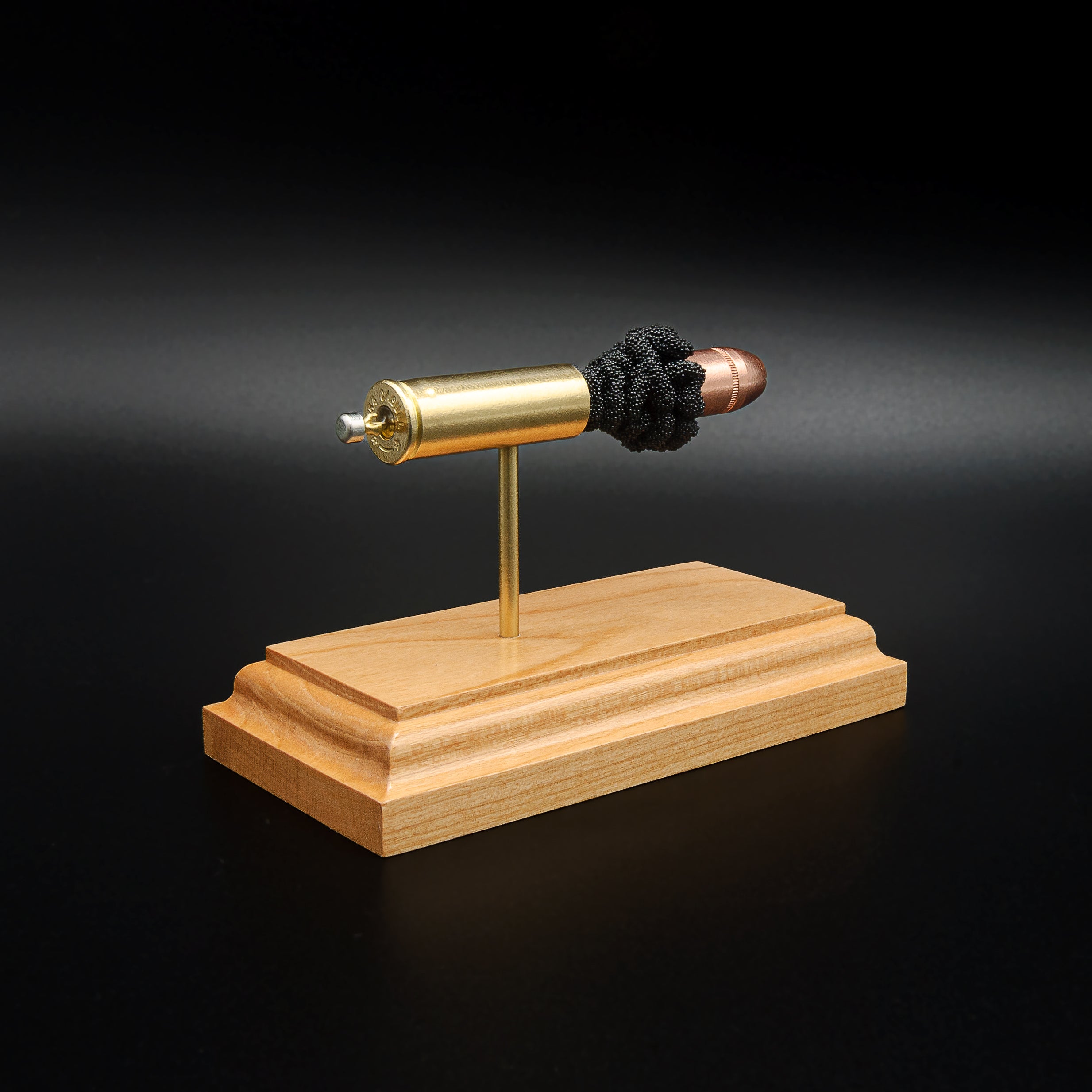 Opposite rear angle of an inert .454 Casull exploded cartridge display featuring a Hornady XTP JHP 300gr hollow point bullet, simulated powder, brass case, and handcrafted cherry wood base.