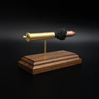 Rear left angle of a 45-70 Government Hornady Sub-X 410gr cartridge anatomy display showing the cartridge headstamp, primer cup, and exposed internal components on a walnut base.