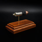 Rear view of a .45 Auto cartridge display showing the base of the nickel casing and primer mounted above a rosewood base