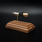 Angled view of a .45 Auto Federal 230gr HST JHP cartridge anatomy display highlighting the projectile, simulated powder, cartridge case, primer cup, and anvil on a walnut wood base.