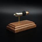 Side view of a .45 Auto Federal 230gr HST JHP cartridge anatomy display with the primer cup, anvil, cartridge case, simulated powder, and projectile visible on a walnut wood base.