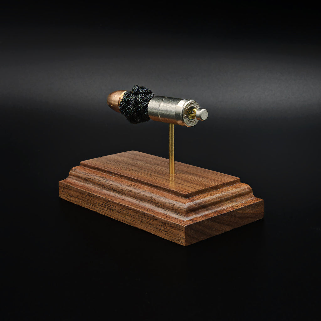 Rear view of a .45 Auto Federal 230gr HST JHP cartridge anatomy display showing the cartridge case head, primer cup, anvil, simulated powder, and projectile on a walnut wood base.