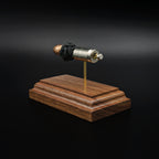 Rear view of a .45 Auto Federal 230gr HST JHP cartridge anatomy display showing the cartridge case head, primer cup, anvil, simulated powder, and projectile on a walnut wood base.