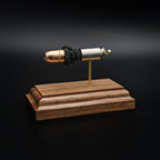 Angled opposite side view of a .45 Auto Federal 230gr HST JHP cartridge anatomy display featuring the primer cup, anvil, cartridge case, simulated powder, and projectile on a walnut wood base.